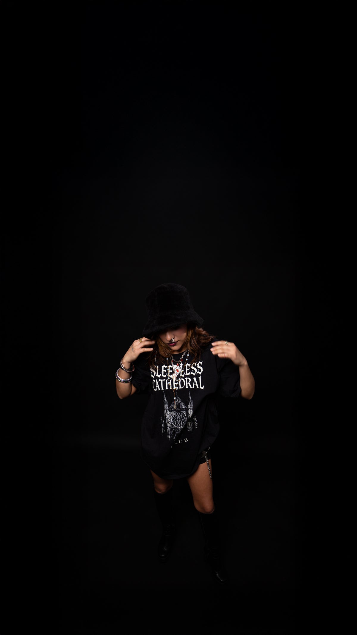 Person wearing a black t-shirt with text on a dark background