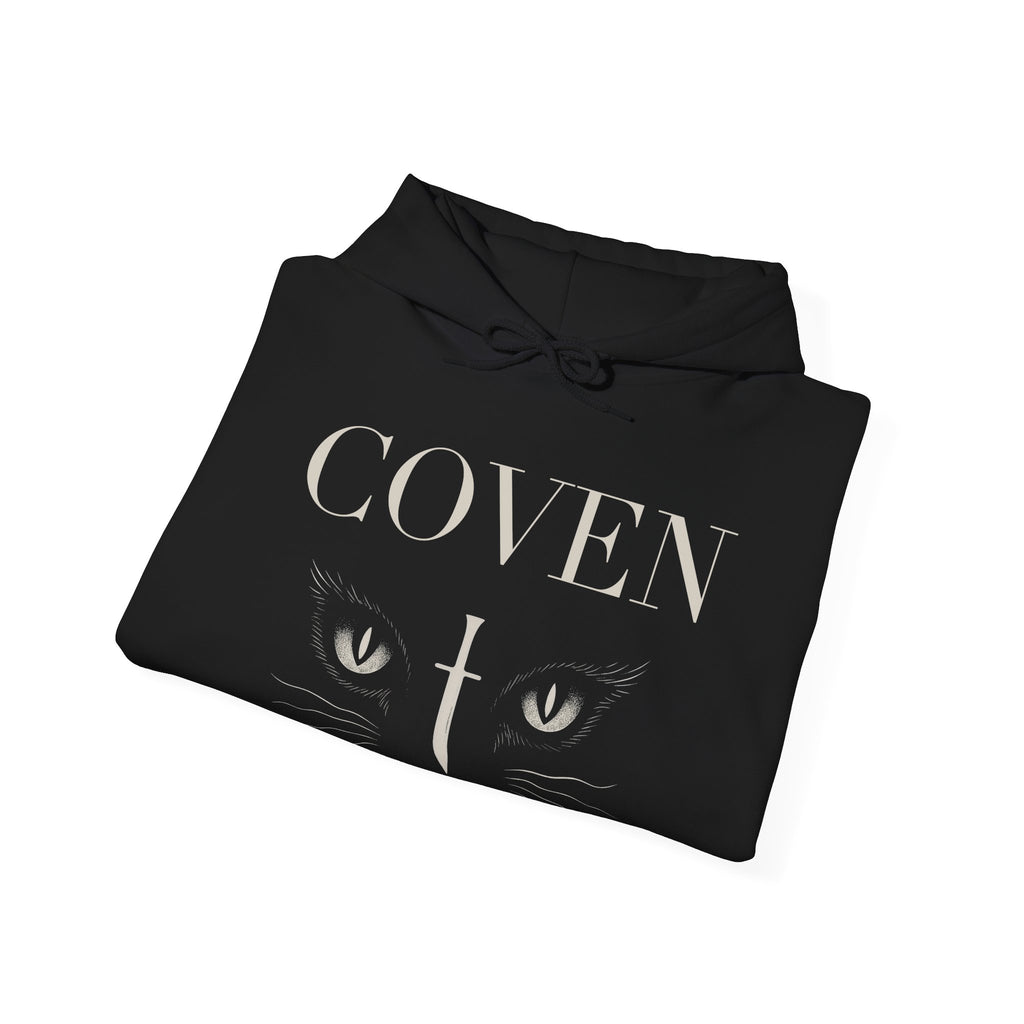 Folded Coven Cat Eye hoodie – black hoodie folded neatly showing 'COVEN' lettering and cat eyes with dagger graphic, gothic streetwear style