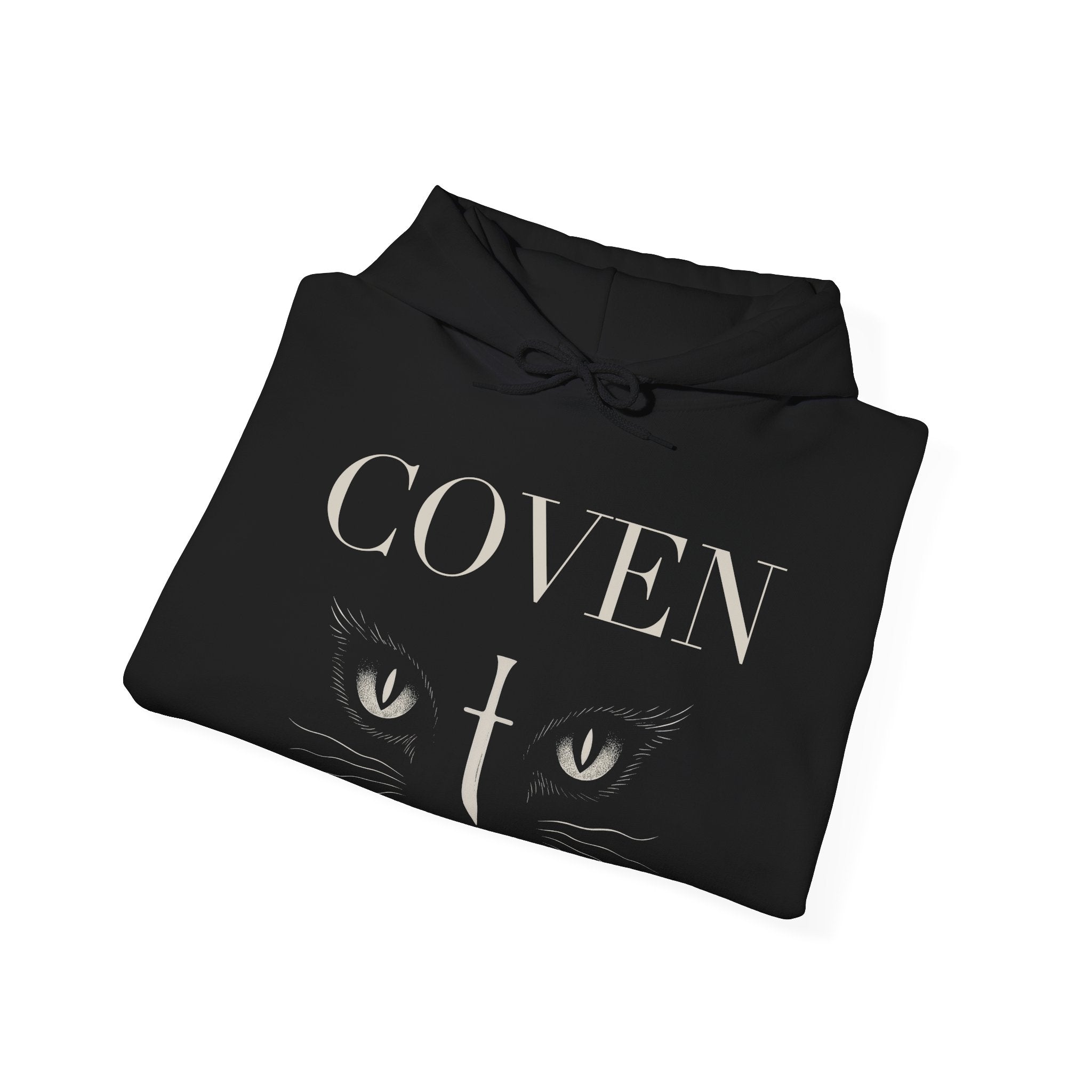 Folded Coven Cat Eye hoodie – black hoodie folded neatly showing 'COVEN' lettering and cat eyes with dagger graphic, gothic streetwear style