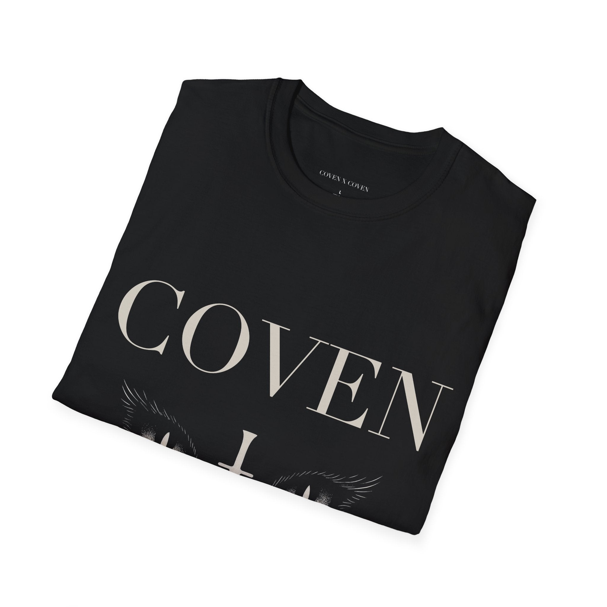 Folded Coven Cat Eye T-shirt – black unisex T-shirt folded neatly showing 'COVEN' lettering and cat eyes graphic, gothic streetwear style