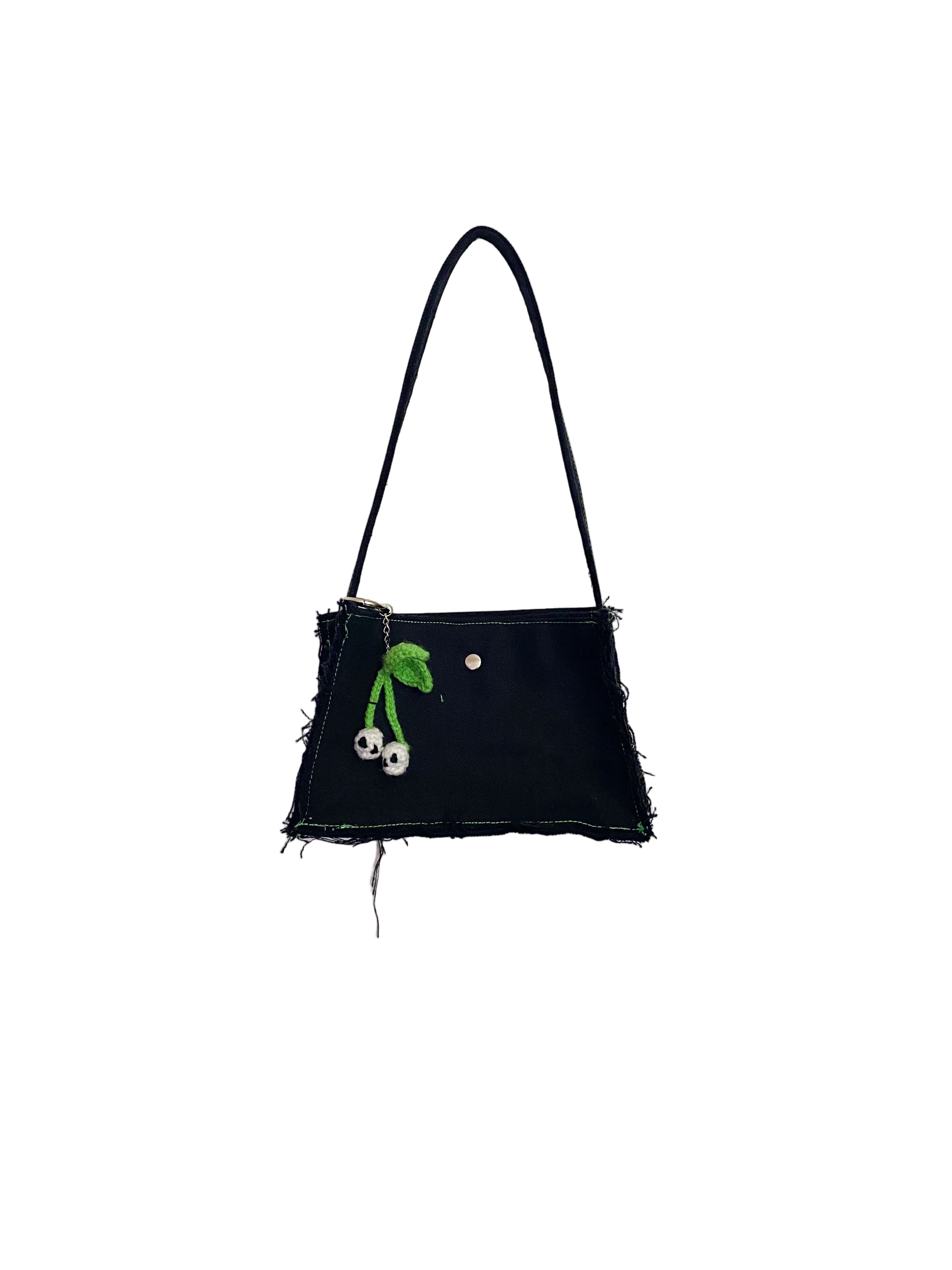 Black handbag with green floral design on a white background