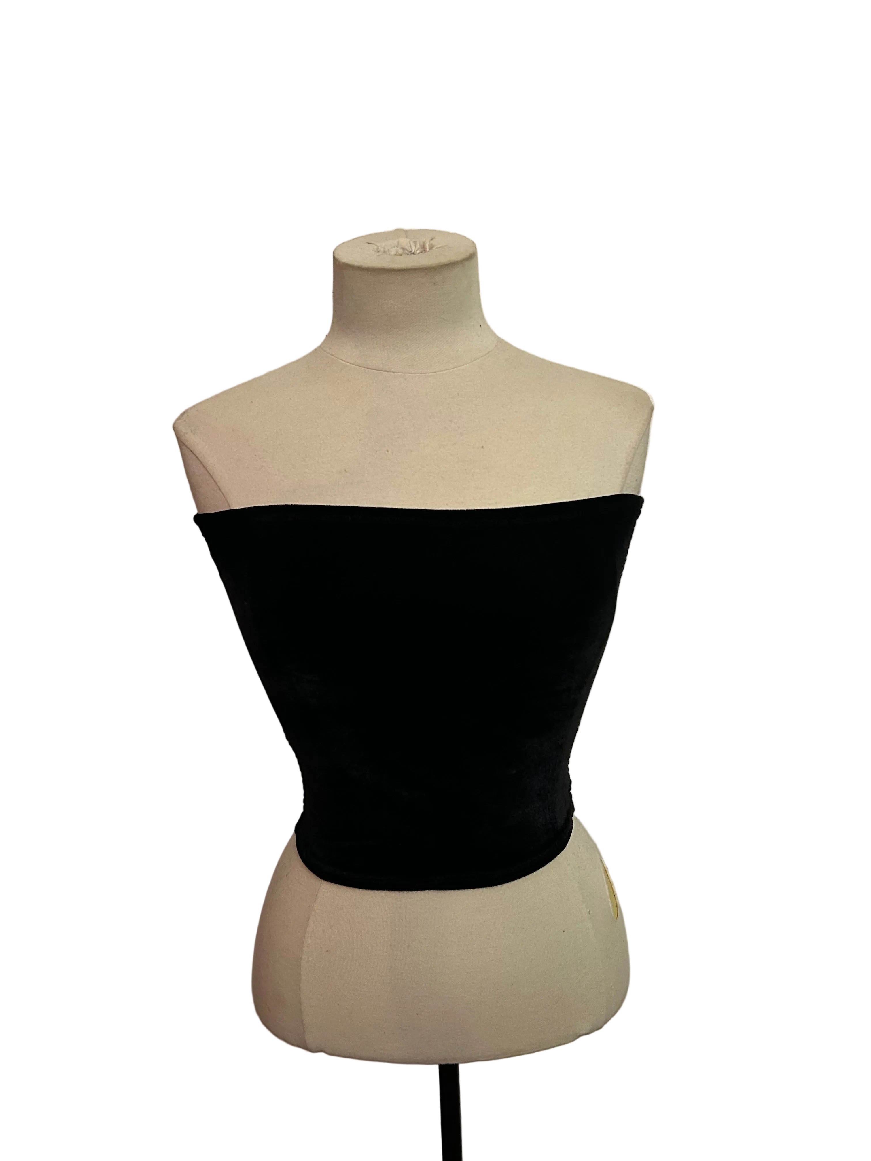 Black strapless top on a mannequin against a white background