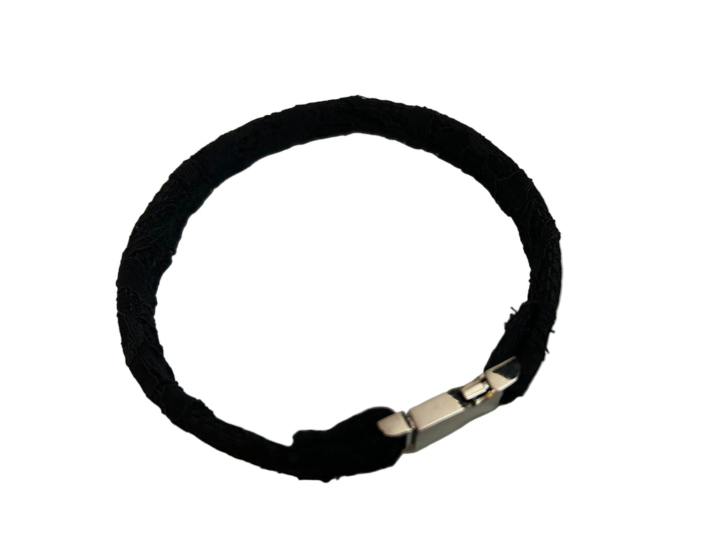 Black choker with a silver clasp on a light gray background